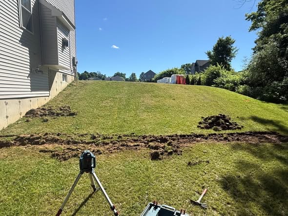 Failing hillside before retaining wall construction — East Brookfield, MA
